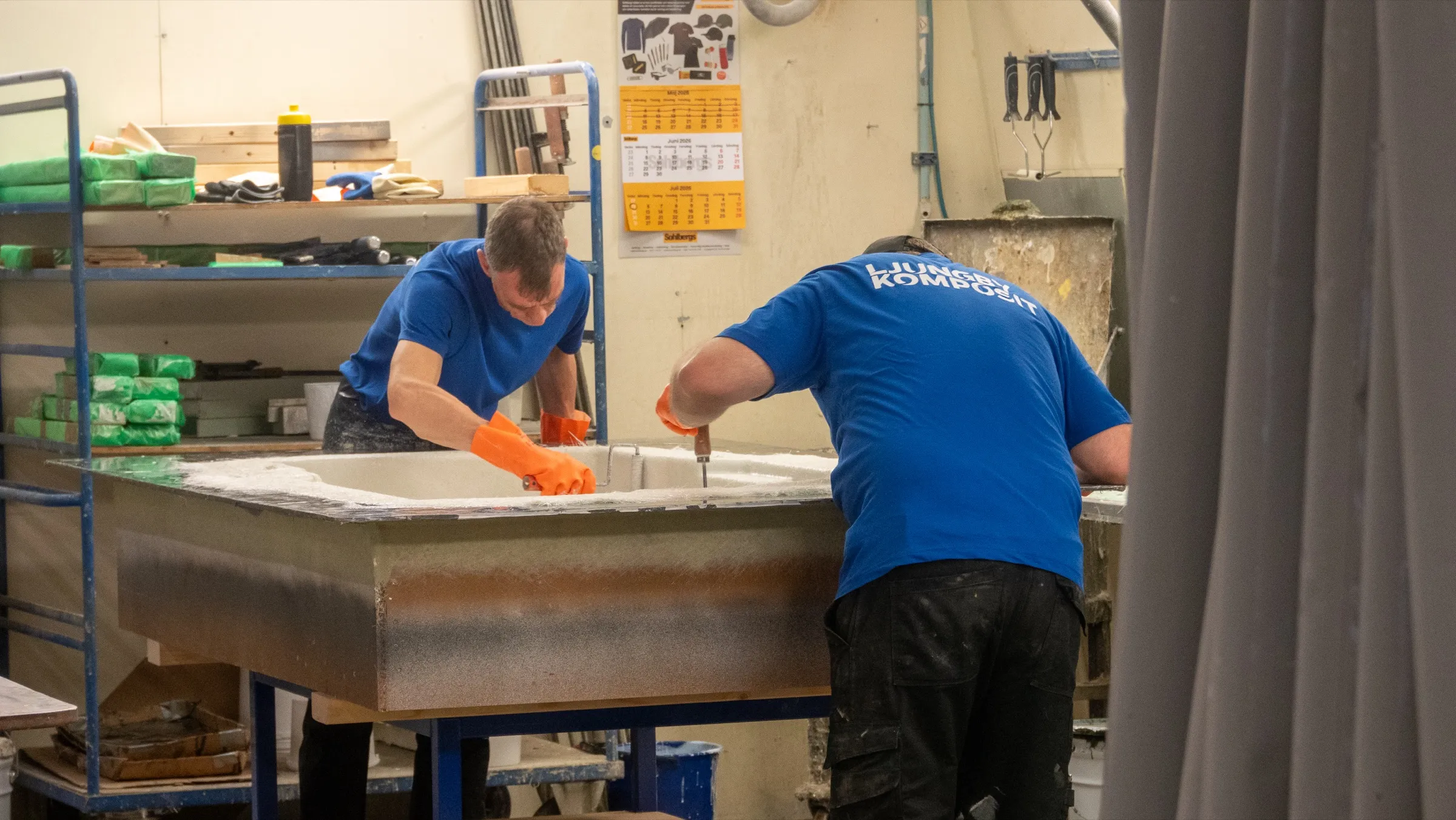 Two colleagues working together at a mould in the workshop