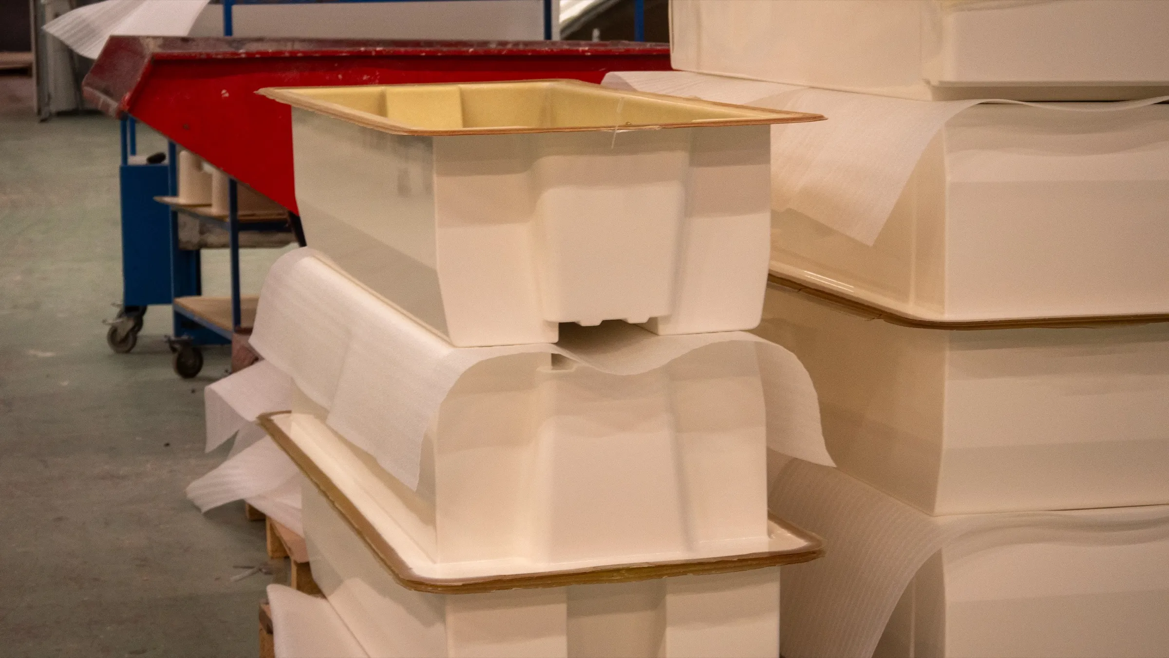 Finished composite parts stacked with interleaving, ready for delivery